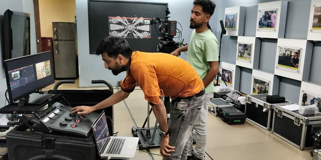 Professional DIT workspace with color grading monitors and technical equipment